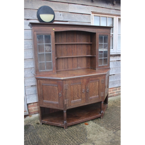 477 - An Arts & Crafts Liberty & Co quartercut oak dresser, the upper section fitted two open shelves flan... 