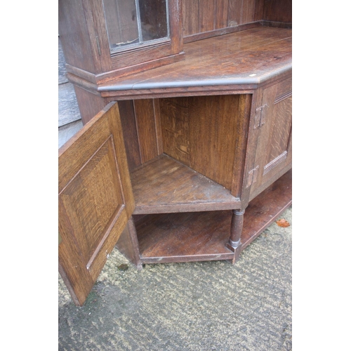 477 - An Arts & Crafts Liberty & Co quartercut oak dresser, the upper section fitted two open shelves flan... 