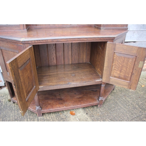 477 - An Arts & Crafts Liberty & Co quartercut oak dresser, the upper section fitted two open shelves flan... 