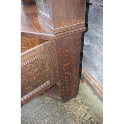 477 - An Arts & Crafts Liberty & Co quartercut oak dresser, the upper section fitted two open shelves flan... 