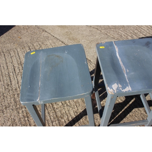 505 - Four blue painted panel seat high stools, on stretchered supports, 13