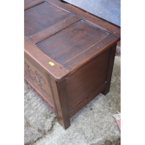 507 - An oak two panel front coffer with carved decoration, 36