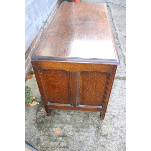 508 - A carved oak panel front coffer of 17th century design, on stile supports, 42