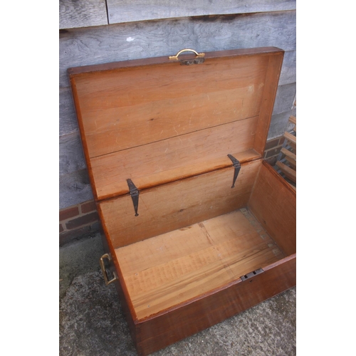 509 - A stained pine hinged trunk with brass handles, 35