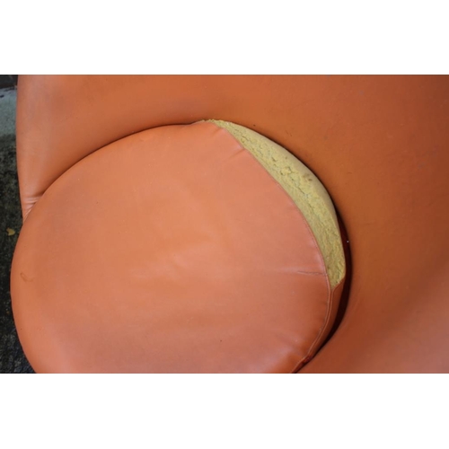 512 - A pair of 1960s tub-shape chairs, upholstered in an orange leatherette, on conical aluminium bases