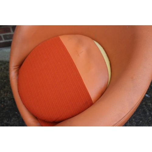 512 - A pair of 1960s tub-shape chairs, upholstered in an orange leatherette, on conical aluminium bases