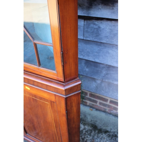 515 - A late 19th century corner display cabinet, upper section enclosed astragal glazed doors over cupboa... 