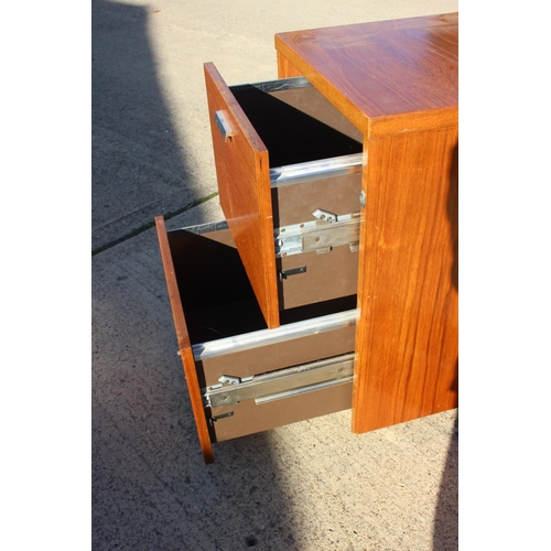 517 - A teak two-drawer filing cabinet, on castored supports, 25 1/2