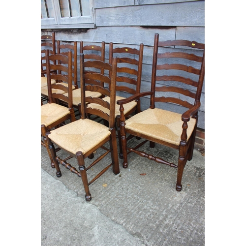 541 - A set of eight oak ladder back dining chairs with rush envelope seats, on turned and stretchered sup... 