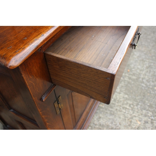 543 - An oak dresser with plate shelves over three drawers and three cupboards enclosed ogee panelled door... 