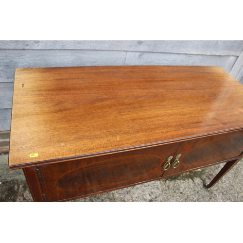 545 - An Edwardian mahogany and banded side cupboard/carving table enclosed two doors, on square taper cas... 