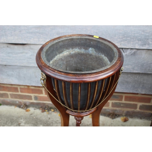 546 - An Edwardian mahogany and box line inlaid jardiniere stand with lion masks and brass swags and line,... 