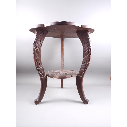 553 - A Japanese carved shaped top two-tier occasional table, on carved cabriole supports, 21