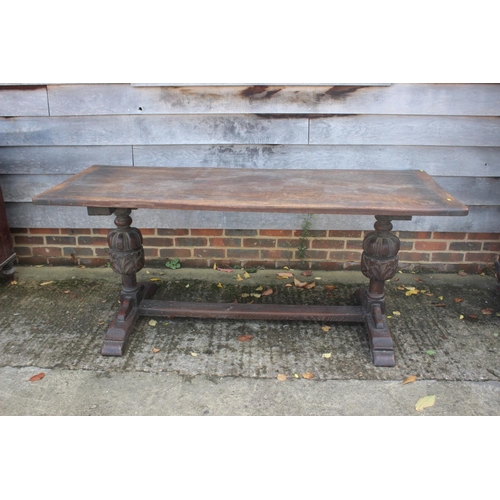 560 - An oak refectory table of 17th century design with cleated planked top, on carved cup and cover supp... 