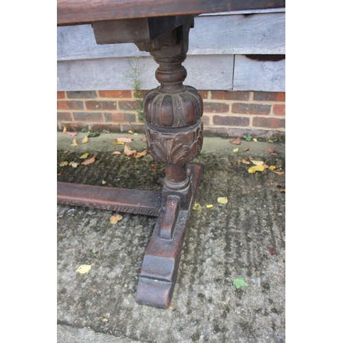 560 - An oak refectory table of 17th century design with cleated planked top, on carved cup and cover supp... 