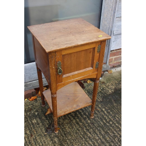 561 - An early 20th century walnut bedside cupboard enclosed one door over undertier, on turned supports, ... 