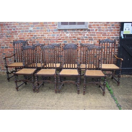 564 - A set of ten carved oak restoration design dining chairs with vertical rail backs, cane seats and lo... 