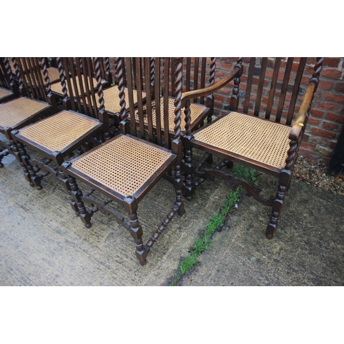 564 - A set of ten carved oak restoration design dining chairs with vertical rail backs, cane seats and lo... 