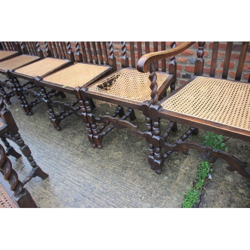 564 - A set of ten carved oak restoration design dining chairs with vertical rail backs, cane seats and lo... 