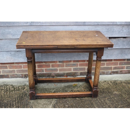 567 - An oak draw leaf table of 17th century design, on turned column and stretchered supports, 41