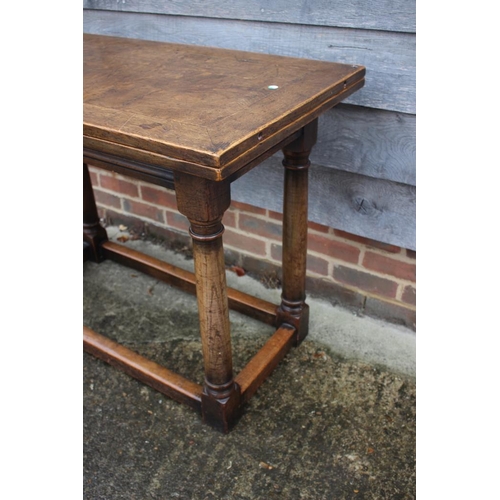 567 - An oak draw leaf table of 17th century design, on turned column and stretchered supports, 41