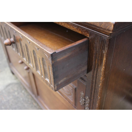 568 - A carved oak court cupboard, the upper section enclosed leaded lattice glazed door over two drawers ... 