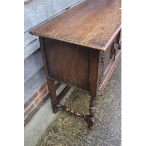 569 - A carved oak sideboard of 17th century design, fitted two drawers over cupboards, on turned and stre... 