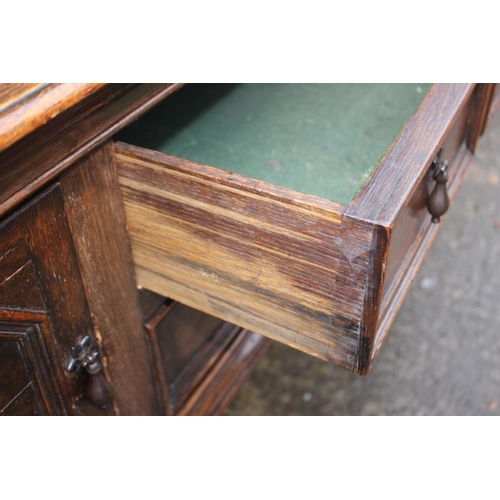 569 - A carved oak sideboard of 17th century design, fitted two drawers over cupboards, on turned and stre... 