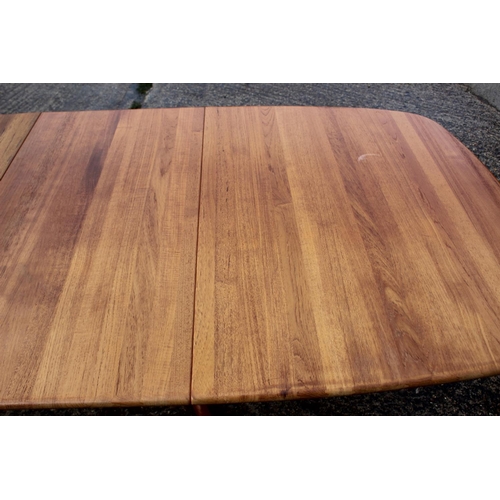 576 - A 1960s teak extending dining table with two extra leaf, on splay supports, 88