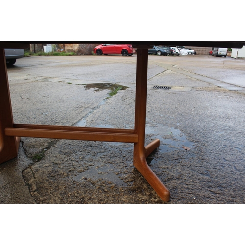 576 - A 1960s teak extending dining table with two extra leaf, on splay supports, 88