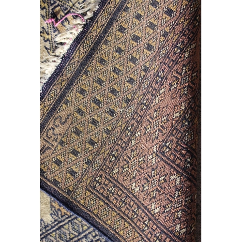 590 - A Bokhara rug of traditional design, in shades of faun, blue, brown and natural, 30