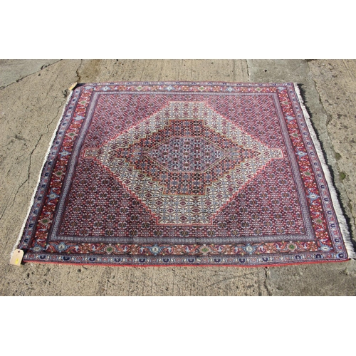 591 - A Persian rug with white ground medallion and multi-borders in shades of blue, red, green brown and ... 