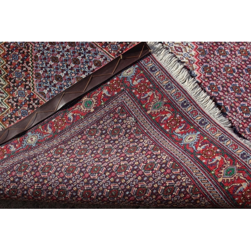 591 - A Persian rug with white ground medallion and multi-borders in shades of blue, red, green brown and ... 