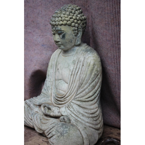 603 - A cast stone seated Buddha, on plinth, 21