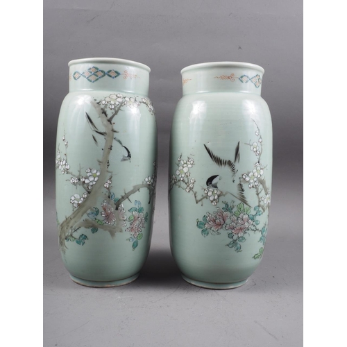 88 - A pair of Chinese celadon glazed and bird decorated cylinder vases, 12 1/4