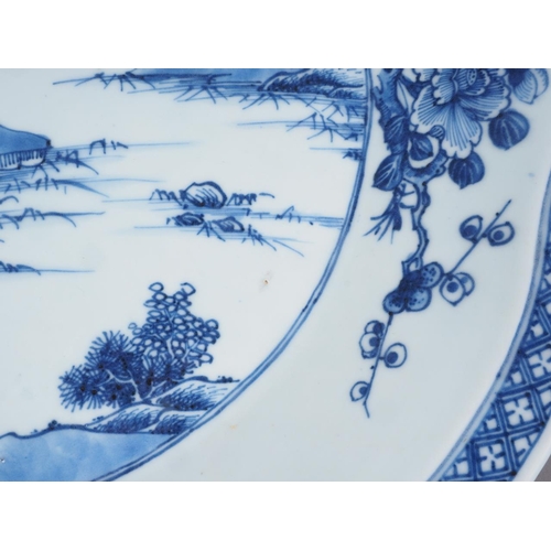 94 - A Chinese blue and white shaped edge dish with landscape decoration and floral borders, 13