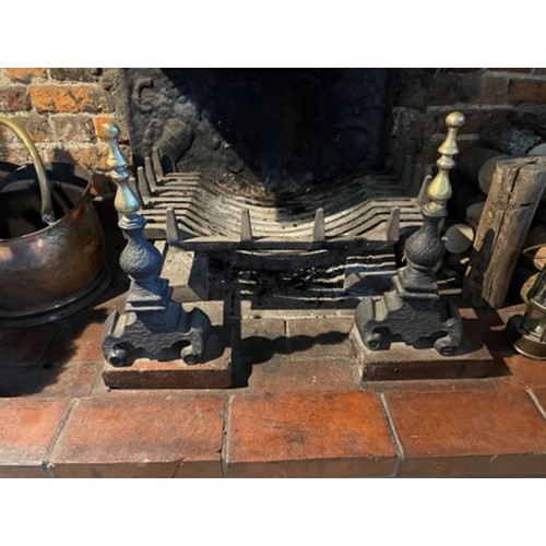 609 - A cast iron fire grate with brass mounted dogs, 24