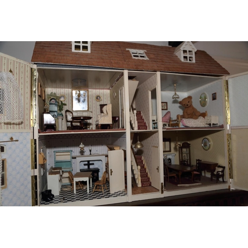 183 - A late 20th century brick effect finish dolls house of three stories with furnishings and effects, 3... 