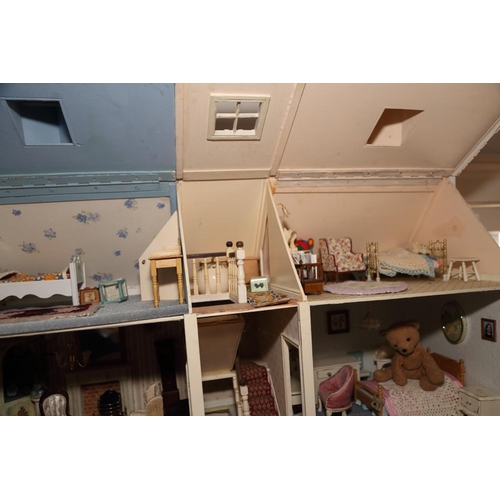 183 - A late 20th century brick effect finish dolls house of three stories with furnishings and effects, 3... 