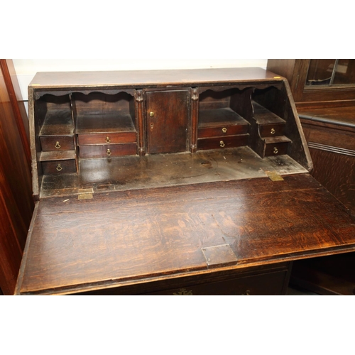 476 - A late 18th century oak bureau with fitted interior, over one long drawer, two short drawers and two... 