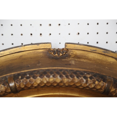 495 - An early 19th century convex wall mirror, in ebonised reeded and gilt frame, plate 15