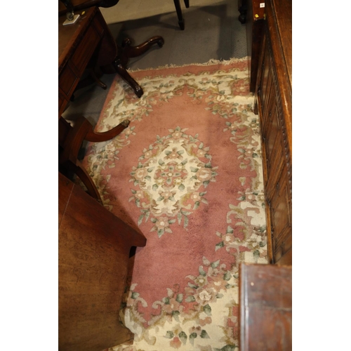 592 - A Super Ganges Indian washed wool rug with floral decoration on a pink ground, 72