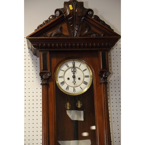 133 - A Vienna regulator type wall clock with eight-day striking movement and white enamel dial, in walnut... 