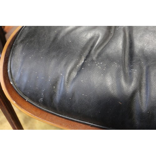 559 - A 1960s Herman Miller black leather seat stool, on quadruple splay supports