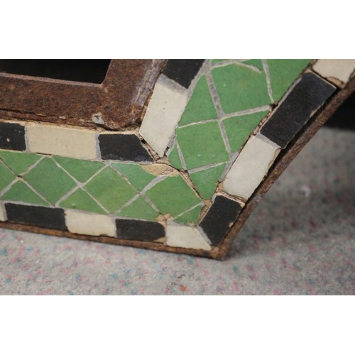 212 - A wrought iron and mosaic design frame, 25