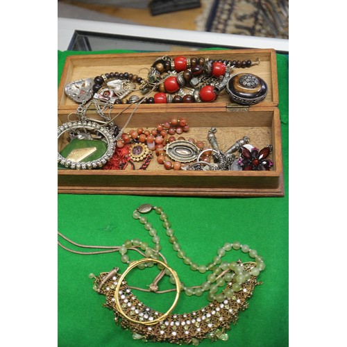 303 - A quantity of costume jewellery, including beaded necklaces, bangles, pendants, etc