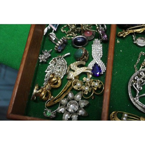 303 - A quantity of costume jewellery, including beaded necklaces, bangles, pendants, etc