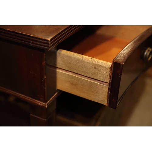 719 - A mahogany serpentine front side table, fitted three drawers, on square taper supports and spade fee... 