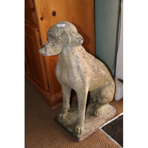 757 - A cast stone figure of a seated hound, 28