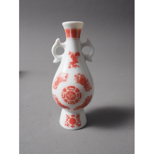 110 - A collection of approximately twenty-three miniature models of Chinese vases, 3 1/2